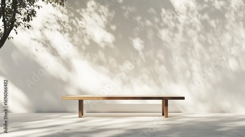 Minimalist Wooden Table Casting Shadows on a White Wall in a Serene Outdoor S...