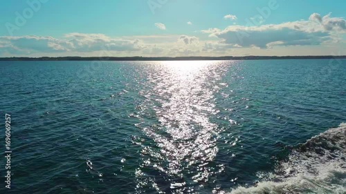 The Sparkling Ocean Waves Dance Gracefully and Beautifully Beneath a Bright and Clear Sky Above