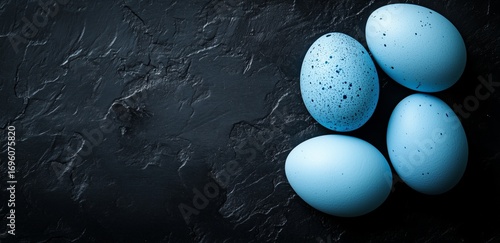 Blue Speckled Eggs Arranged on a Dark Textured Surface in Natural Light.