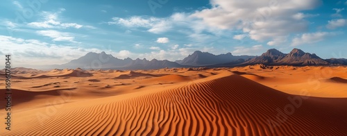 Beautiful Sunset Over Vast Desert Dunes With Soft Golden Light and Distant Mo...