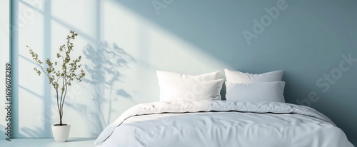 Soft White Bedding on a Serene Blue Wall With Natural Sunlight Illuminating a...