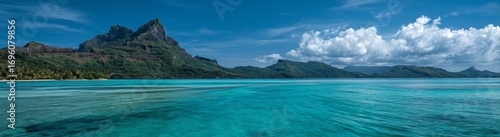 Stunning Turquoise Waters of a Serene Bay With Mountain Backdrop During a Cle...