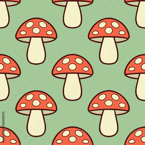 Seamless pattern of red mushrooms with white spots on a light green background