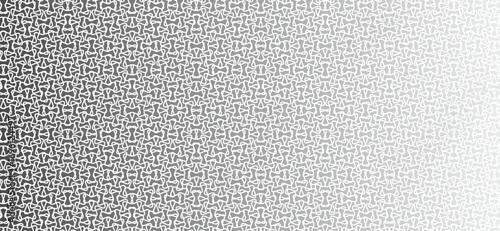 Abstract pattern of repeating geometric shapes fading into white space.