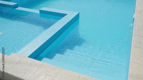 clear blue water in swimming pool with steps, slow motion
