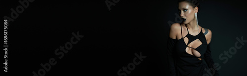 Enchanting demoness in a stunning black costume for a Halloween celebration