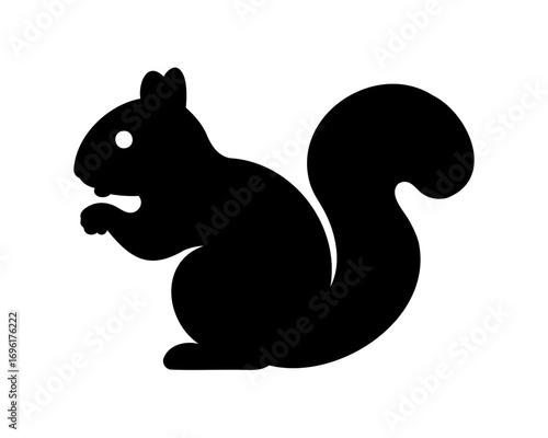 Silhouette of a Squirrel Standing Alert with a Large Bushy Tail