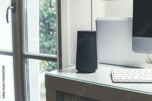 Smartphone, wifi speaker, router and computer on desk. Technology, domotics, home automation concept