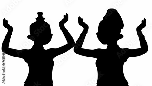 Silhouette of two women in traditional attire with arms raised in a synchronized dance movement pose