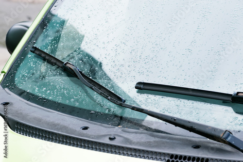 wipers on wet car windshield. Close-up