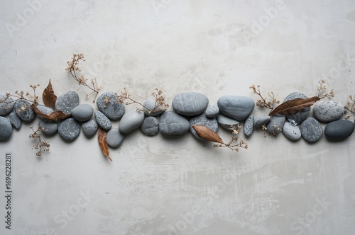 Abstract arrangement of tiny gray and blue pebbles mixed with dried foliage. Conveys tranquility, calmness, and serenity.