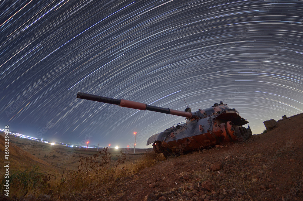 Fototapeta premium star trail photo with an abandoned tank