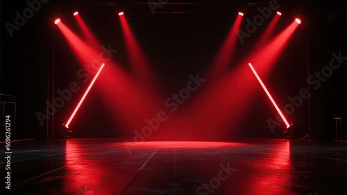 Vibrant red spotlights cast dramatic beams across an empty, reflective performance stage, setting an intense atmosphere for an upcoming show or event
