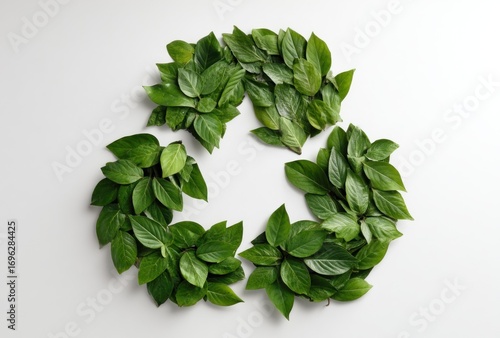 Recycle symbol formed by vibrant green leaves. Concept showing sustainability, growth, and environmental awareness, isolated on white