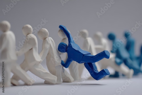 Blue figure stumbles in a line of white figures
