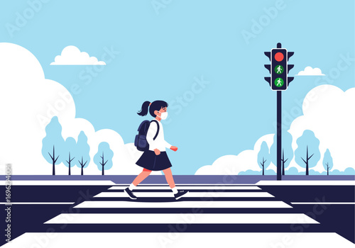 Child wearing mask and backpack walks across street at pedestrian crossing with traffic light signaling green