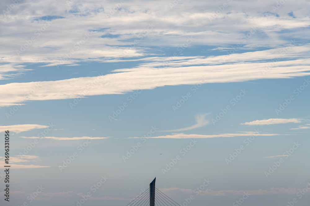 Fototapeta premium idyllic cloudscape with a suspension bridge