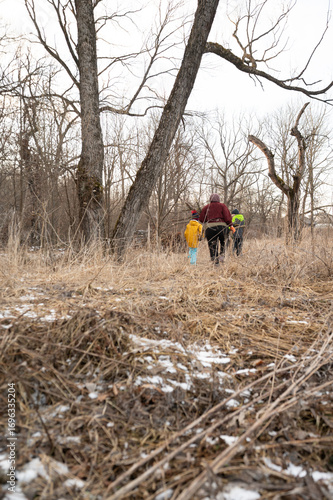 Wallpaper Mural Exploring a winter landscape with children enjoying nature while walking through a field near bare trees on a chilly day in the countryside Torontodigital.ca