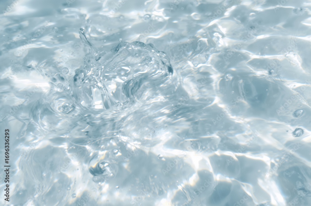 Obraz premium Blurred transparent water surface with bubbles and splashes, soft and clear texture. Modern abstract natural backdrop with sunlight reflections and space for text.