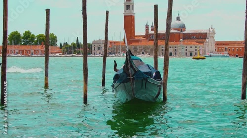 The tourist area of Venice with boats on the water and the architecture of the old city.