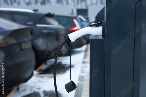 Electric Vehicle Charging Station and Cars in Winter