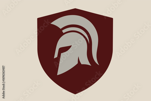 Spartan warrior helmet inside a protective shield emblem.
