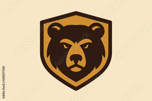 Bear head emblem on a shield with a stern expression.
