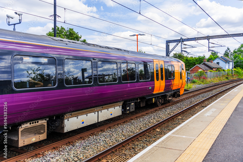 Obraz premium Electrified suburban passenger rural commuter railway line England UK