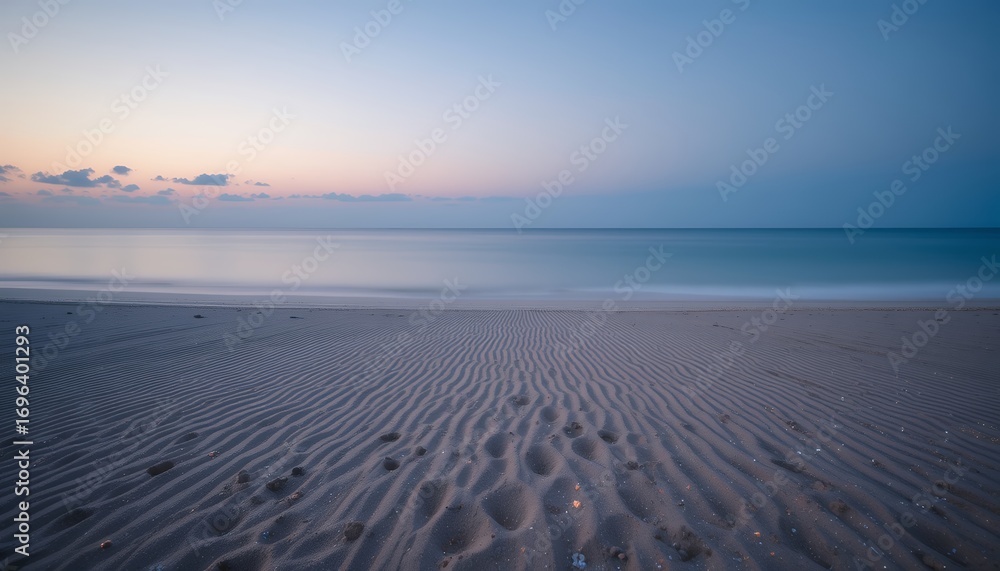Fototapeta premium Serene ocean horizon with patterned sandy beach under soft pastel sky during twilight