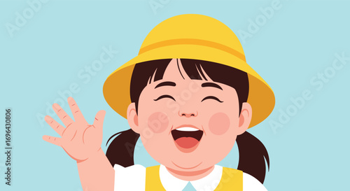 A cheerful little girl wearing a yellow hat waves hello to you with a big smile