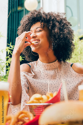 Wallpaper Mural Young black woman enjoying fast food at a restaurant Torontodigital.ca