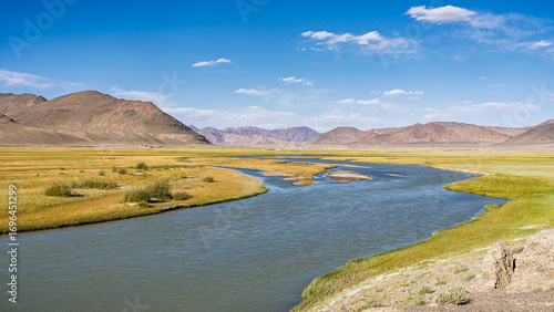 Summer mountain landscape view of Murghab river in high altitude valley along Pamir Highway, Gorno-Badakhshan, Tajikistan Pamir