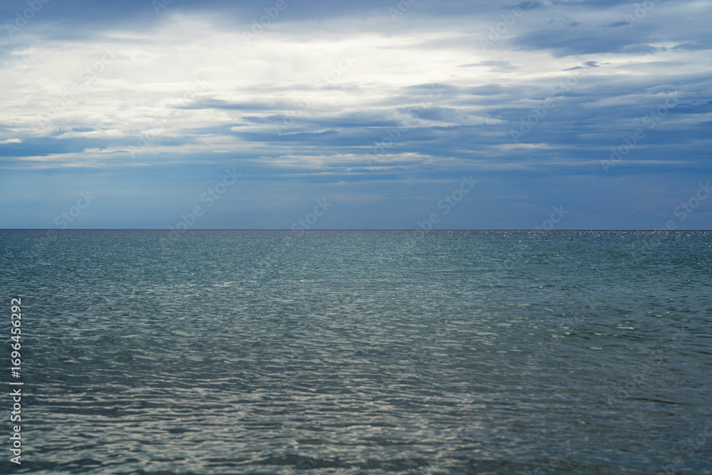 Fototapeta premium Seascape in Corfu Greece. Blue sea and sky with clouds. Natural background