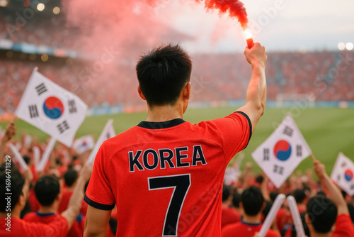 Korean soccer fan with red flare in crowded stadium celebration