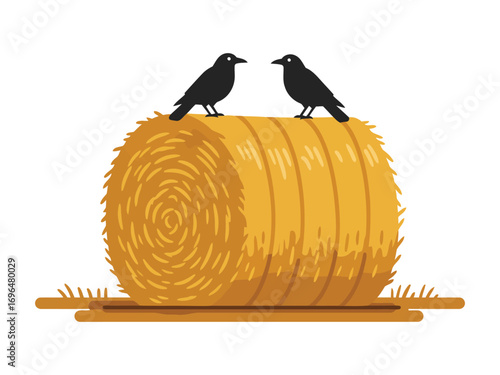 Two crows perched atop a large round hay bale.