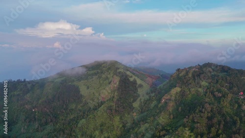 Cinematic drone orbit revealing a vast landscape with clouds