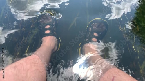 A surfer is floating on a paddleboard along the river.