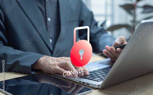 Fotografie Businessman using laptop with virtual key and confidential access for corporate