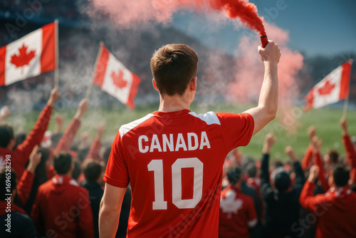 Canadian soccer fan holding red smoke flare in stadium