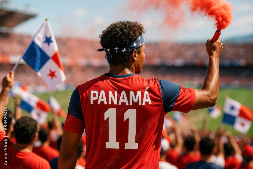 Fototapeta premium Panamanian soccer fan raising red smoke flare in stadium crowd