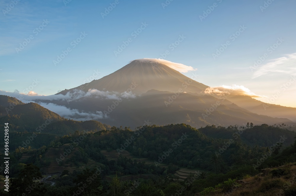 Fototapeta premium Morning sunlight warms the air around the mountain peak.