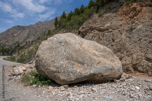 Impact of seismic activity on a high-altitude road with massive rockfall blocking the path