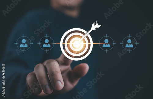 Billede på lærred Businessman finger pointing at target with dart arrow symbol