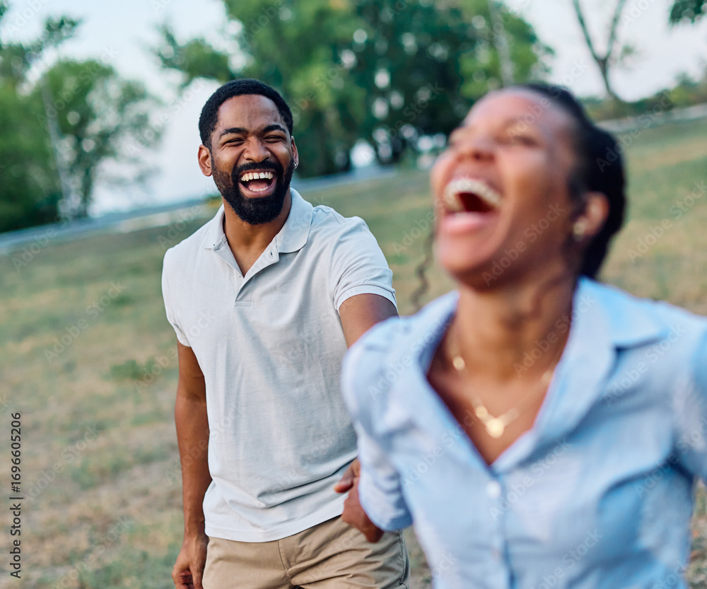 Obraz premium Happy active young black couple having fun walking running holding hands and bonding in park or nature outdoors
