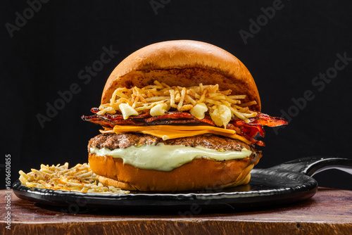
Beef burger with cheddar cheese, straw potatoes, fried bacon and mayonnaise