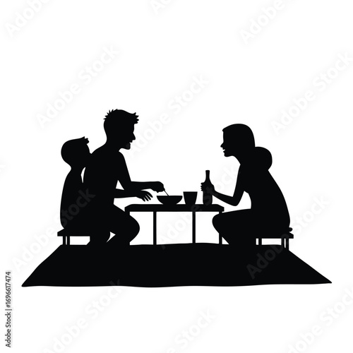 Family picnic silhouette with two children and adults at a table