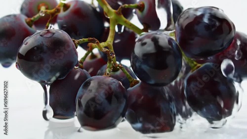 Vibrant Grapes: A close-up shot showcases a cluster of glistening, ripe grapes, their dark skins shimmering with moisture, captured in a high-quality, realistic style.