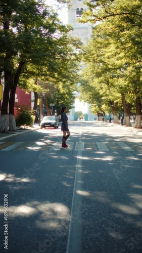 Wallpaper Mural Stylish woman crossing street in city on sunny day Torontodigital.ca