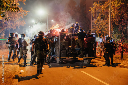 Clashes between law enforcement and protesters in urban area during nighttime unrest