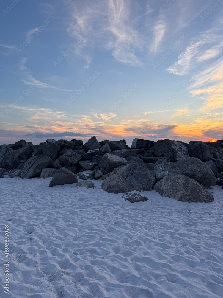 Obraz premium Destin, Florida East Pass rocky jetties with sunset sky background 